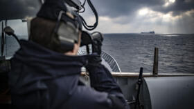 A crew member monitors the horizon from the bridge deck of patrol ship HMS Carlskrona (P04) as part of the NATO Baltic Sea patrol mission on February 4, 2025.