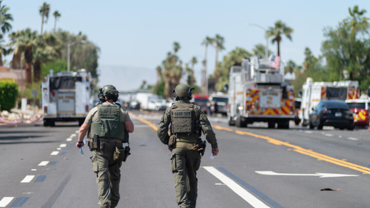 Deux démineurs marchent près de la scène de l'explosion d'une bombe qui a endommagé une clinique spécialisée dans la procréation médicalement assistée (PMA) et fait un mort, le 17 mai 2025 à Palm Springs, en Californie