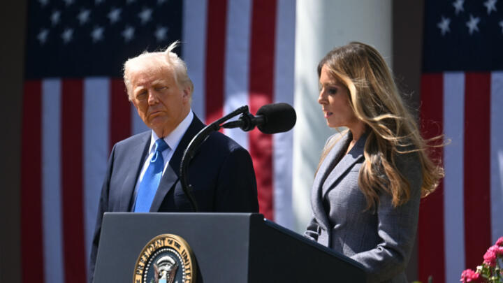 US President Donald Trump looks on as First Lady Melania Trump speaks at a signing ceremony of the "Take It Down Act" outlawing 'revenge porn'