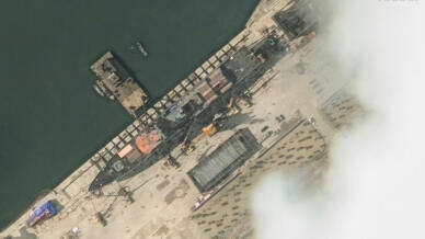 This handout satellite image from Maxar Technologies shows a general view of a new North Korean warship at a harbour ahead of its launch