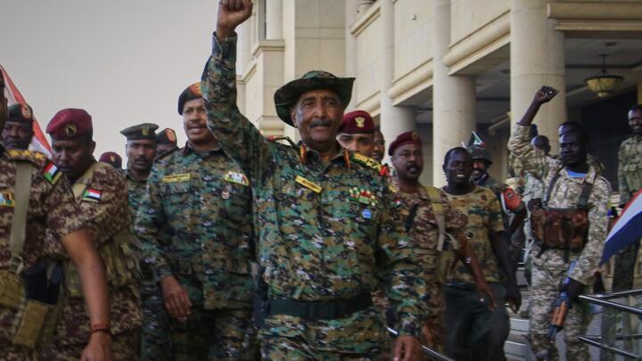 Sudan's military chief Gen. Abdel-Fattah Burhan center, is greeted by troops as he arrives at the Republican Palace, recently recaptured from the Rapid Support Forces paramilitary group, in Khartoum, 