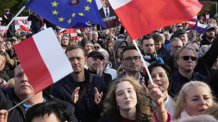 Supporters of Warsaw Mayor Rafal Trzaskowski, a liberal candidate in Poland's presidential election, during a campaign stop, in Lodz, Poland, Friday, May 9, 2025.