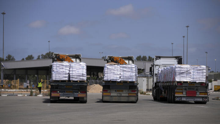 Trucks carrying humanitarian aid for Gaza wait at the Kerem Shalom crossing in southern Israel on May 19, 2025.