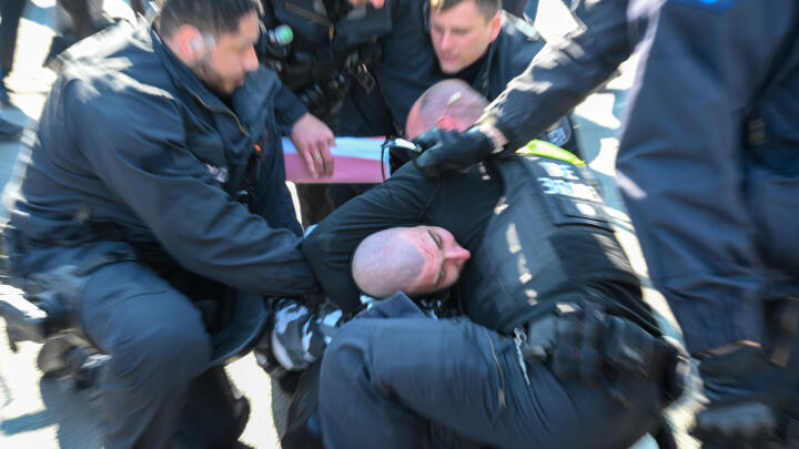 Police detain a protester during a demonstration by far-right supporters in Berlin on March 22, 2025