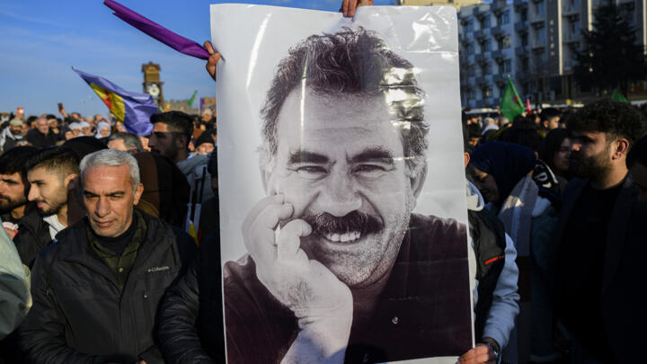 Supporters of the Kurdistan Workers' Party (PKK) hold up a portrait of the party's jailed leader Abdullah Ocalan on February 27, 2025 in Diyarbakir, southeastern Turkey.