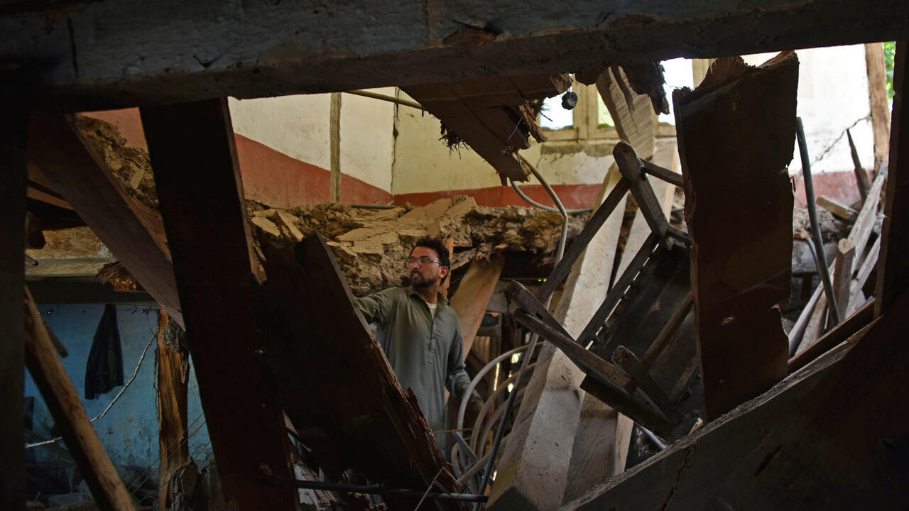 A man in Jura village in the Neelum Valley inspects his damaged home after the latest India-Pakistan fighting