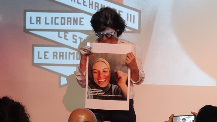 Filmmaker Sepideh Farsi holds a picture of Gaza photojournalist Fatma Hassona in Cannes on May 15, 2025.
