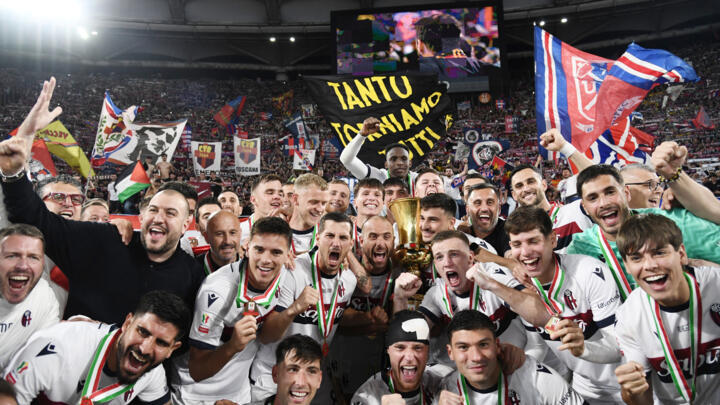 Bologna players celebrate their third Italian Cup title.